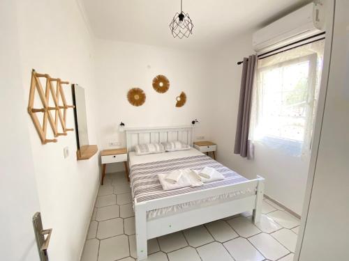 a bedroom with a white bed and a window at Bodrum Nuran Boutique Apart in Bodrum City