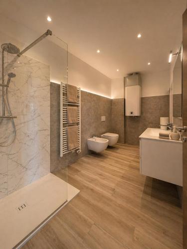 a bathroom with a shower and a toilet and a sink at Lake View Apartament 39 - Free Parking & Terrace in Cadegliano Viconago