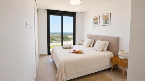 a bedroom with a bed with a view of the ocean at Villa Kala in Polop