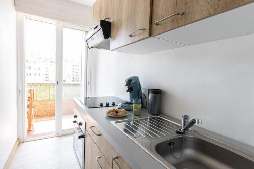 a kitchen with a sink and a counter top at "U Valincu" – Studio Centre Plage | by Efficios in Propriano