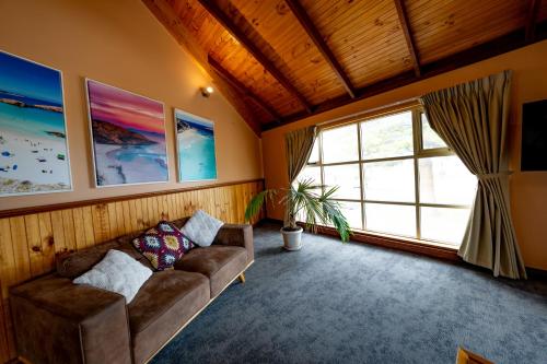 a living room with a couch and a window at Esperance Foreshore Apartments in Esperance