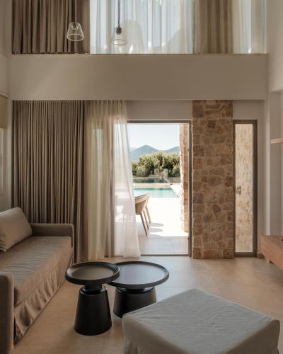 a living room with a couch and a table at Tomas Villas in Paleros