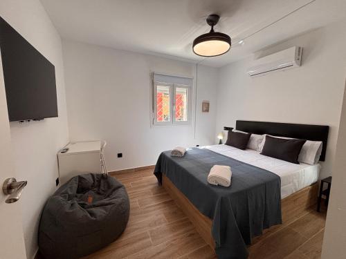 a bedroom with a bed and a bean bag chair at Apartamentos Cañada Sierra 23 in Talavera de la Reina