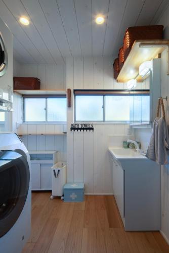 a small kitchen with a sink and a counter at Sotoura Sunrise Cottage 30m from Beach in Shimoda