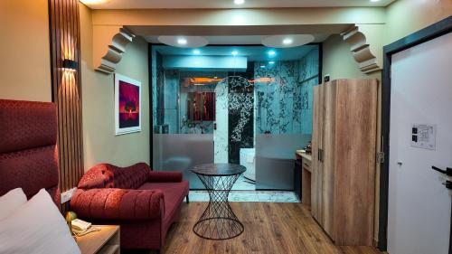 a living room with a red couch and a table at Viva Rooms in Istanbul