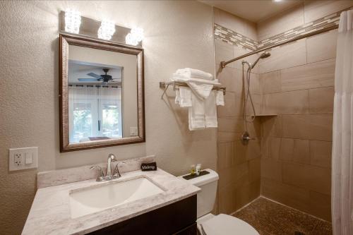 a bathroom with a sink and a toilet and a mirror at Lantern Light Inn - Romantic Getaway in Sedona