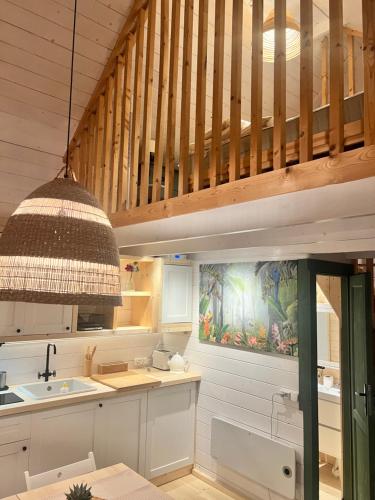 a kitchen with a sink and a wooden ceiling at Domki nad morzem Sasino Mojo Miodno Checz in Sasino