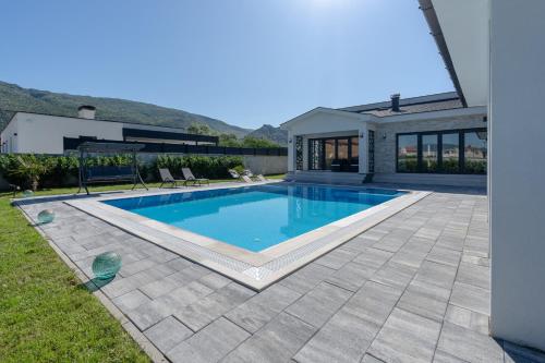 a swimming pool in the backyard of a house at Villa Mirage in Blagaj