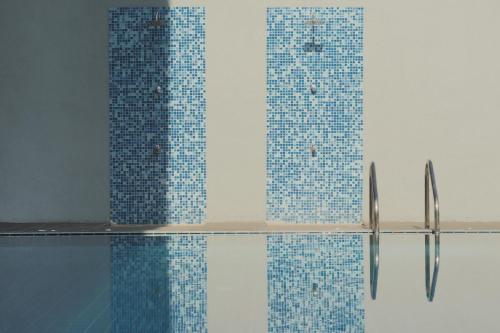 a bathroom with blue tiles on the wall at The Seascape in Matara