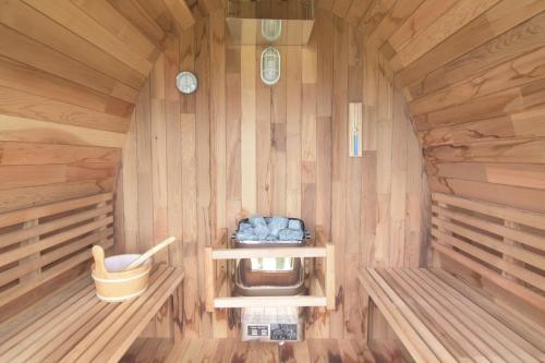 a sauna with a toilet in a wooden cabin at at60% - Vacation STAY 53162v in Nishibaru