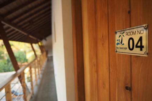 a sign on the door of a house with a room at The Seascape in Matara