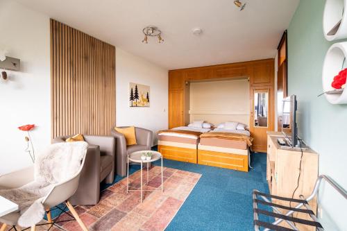 a small room with two beds and a couch at Appartement Bergluft in Sasbachwalden