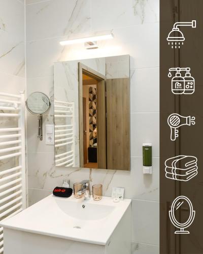 a bathroom with a white sink and a mirror at Lumen Gasztropanzió in Eger
