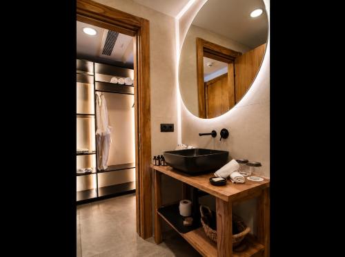 a bathroom with a sink and a mirror at The Local House Alaçatı in Alaçatı
