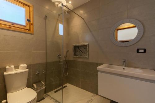 a bathroom with a shower and a toilet and a sink at Amun Dahab Hotel in Dahab