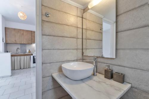 a bathroom with a large white bowl sink on a counter at Libyan Sea Sunset in Kerames