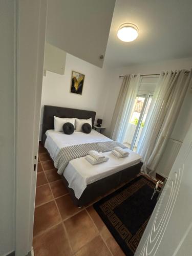 a bedroom with a large bed and a window at Mystegna beach 1 in Skala Mistegnon