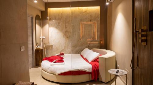 a bedroom with a bed with red and white sheets at charme suite delux in Terrasini