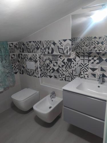 a bathroom with a sink and a toilet at La casa di Rosy in Alba Adriatica