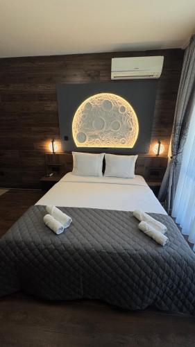 a bedroom with a large bed with two towels on it at MitProt Panorama Bay 2 Studio 93 in Sveti Vlas