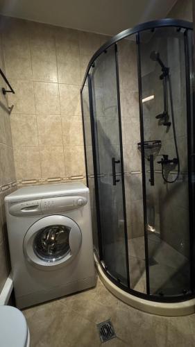 a washing machine and a shower in a bathroom at MitProt Panorama Bay 2 Studio 93 in Sveti Vlas
