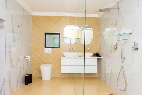 a bathroom with a sink and a shower at RiverfrontOasis - Huge Backyard, Pool, Grand Piano in Sandton