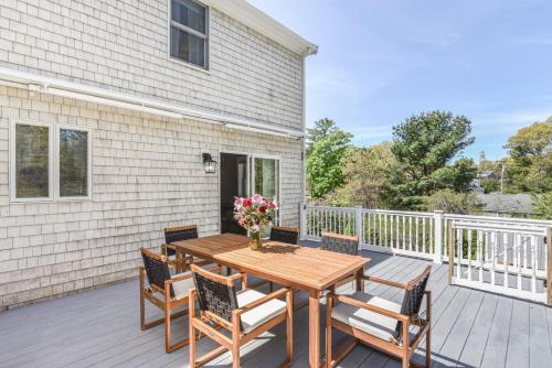 a wooden table and chairs on a deck at Corn Hill Ranch in Falmouth