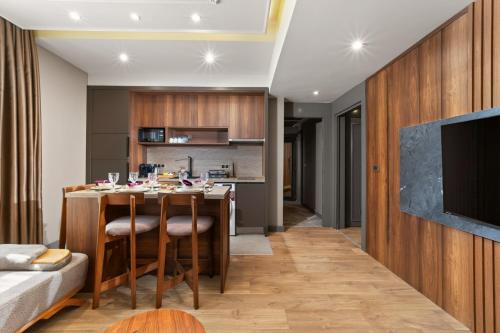 a kitchen and living room with a table and a couch at Taksim Premium Residence in Istanbul