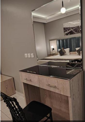 a large mirror in a bedroom with a bed at شقق ازار المخدومه in Medina