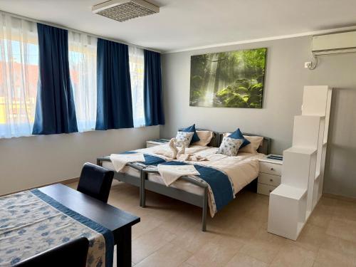 a hotel room with two beds and a table at Apartments MIYABI in Maribor