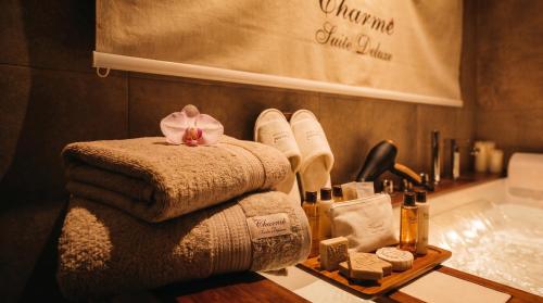 a bathroom with a pile of towels and a sink at charme suite delux in Terrasini