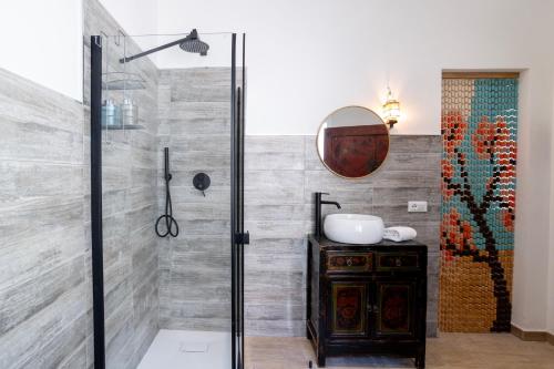 a bathroom with a shower and a sink at Domo Cadò in Berchidda