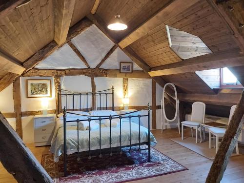 a bedroom with a bed in a attic at Longhouse - Y Beudy in Rhayader