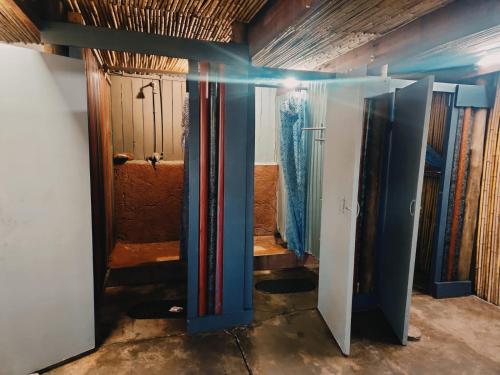 a room with a bunch of doors in a room at Hazyview Adventure Backpackers in Hazyview