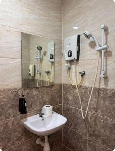 a bathroom with a sink and a shower at Q Inn by Pillow Plus in Petaling Jaya
