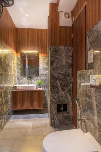 a bathroom with a shower and a toilet and a sink at The Royal Apartments Manor I Roof Top Restaurant I Self Cooking Available I Lift I 7o1827o7o3 in Kasauli