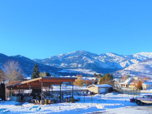 a pavilion in the snow with mountains in the background at Mountain View Lodge in Chelan
