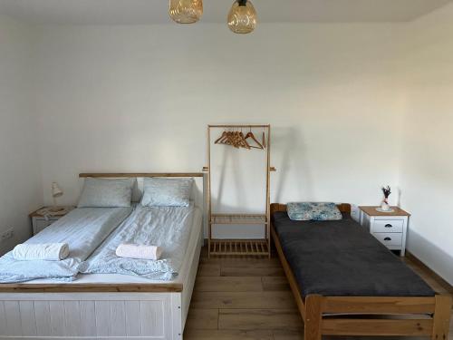 a bedroom with a large bed and a night stand at Apartament z pianinem in Grajewo
