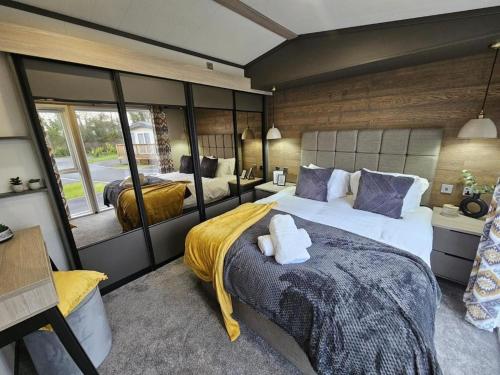 a bedroom with two beds and a large window at Robin Lodge in Amotherby