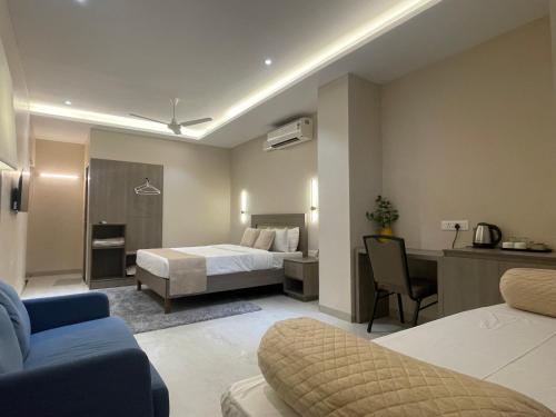 a hotel room with a bed and a desk at Raghav Residency in Vellore