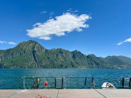 a view of a large body of water with mountains at Appartamento Zu fronte lago con piscina in Fonteno