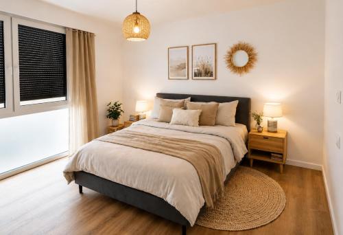 a bedroom with a large bed and a large window at StayIN Suites in Griesheim