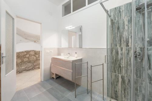 a bathroom with a sink and a shower at Al centro del Borgo in Calasetta