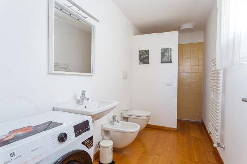 a bathroom with a sink and a toilet and a mirror at Yourbanflat Ring River in Padova