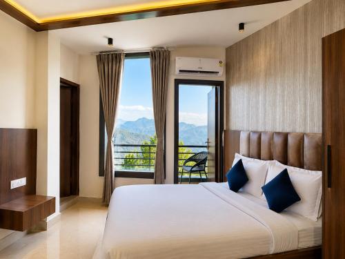 a bedroom with a large bed with a large window at Hotel Heaven and Hills in Kasauli