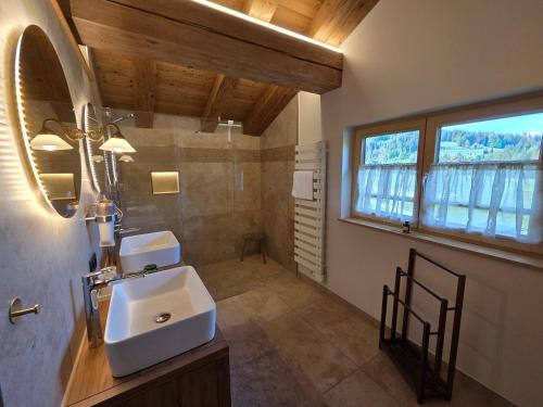a bathroom with a sink and a mirror at Eberlehof in Riezlern