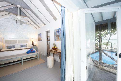 a bedroom with a bed and a balcony at Tiamo Resort in Congo Town