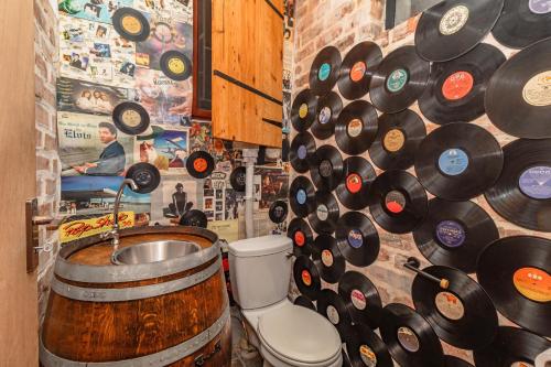 a bathroom with a barrel sink and a wall of records at Ruby on Hamilton in Windsor Park