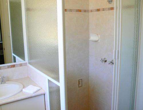 a bathroom with a shower and a sink at Geraldton Luxury Vacation Home with free Streaming in Geraldton
