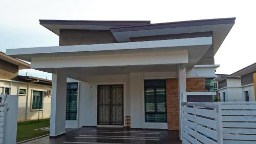 a house with a white fence in front of it at Siantan - Near Std Hang Jebat, Sg Udang & UITM Lendu in Melaka